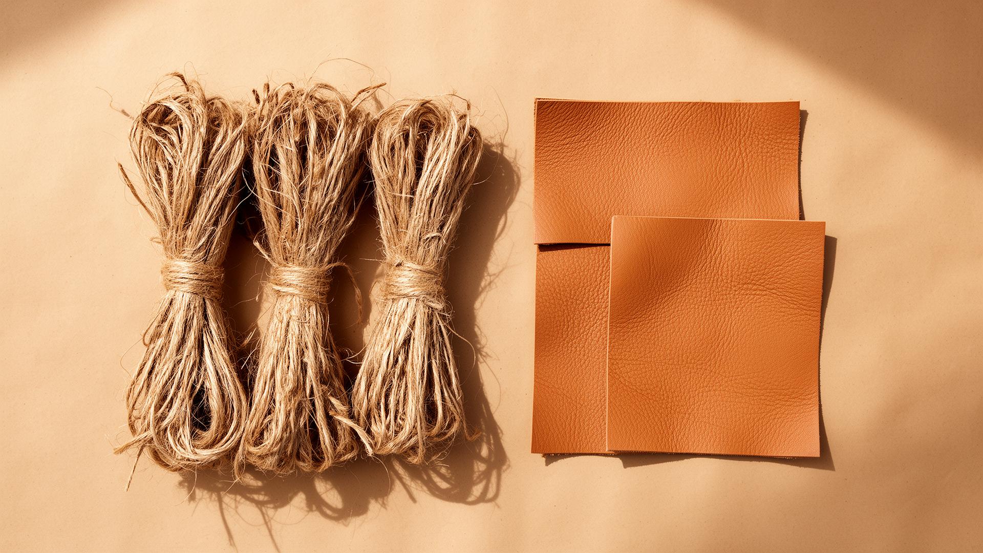 Raw plant fibres next to finished leather-alternative material swatches